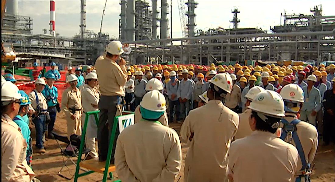 Hundreds of workers in hard hats gathered for a safety talk at a refinery in Singapore
