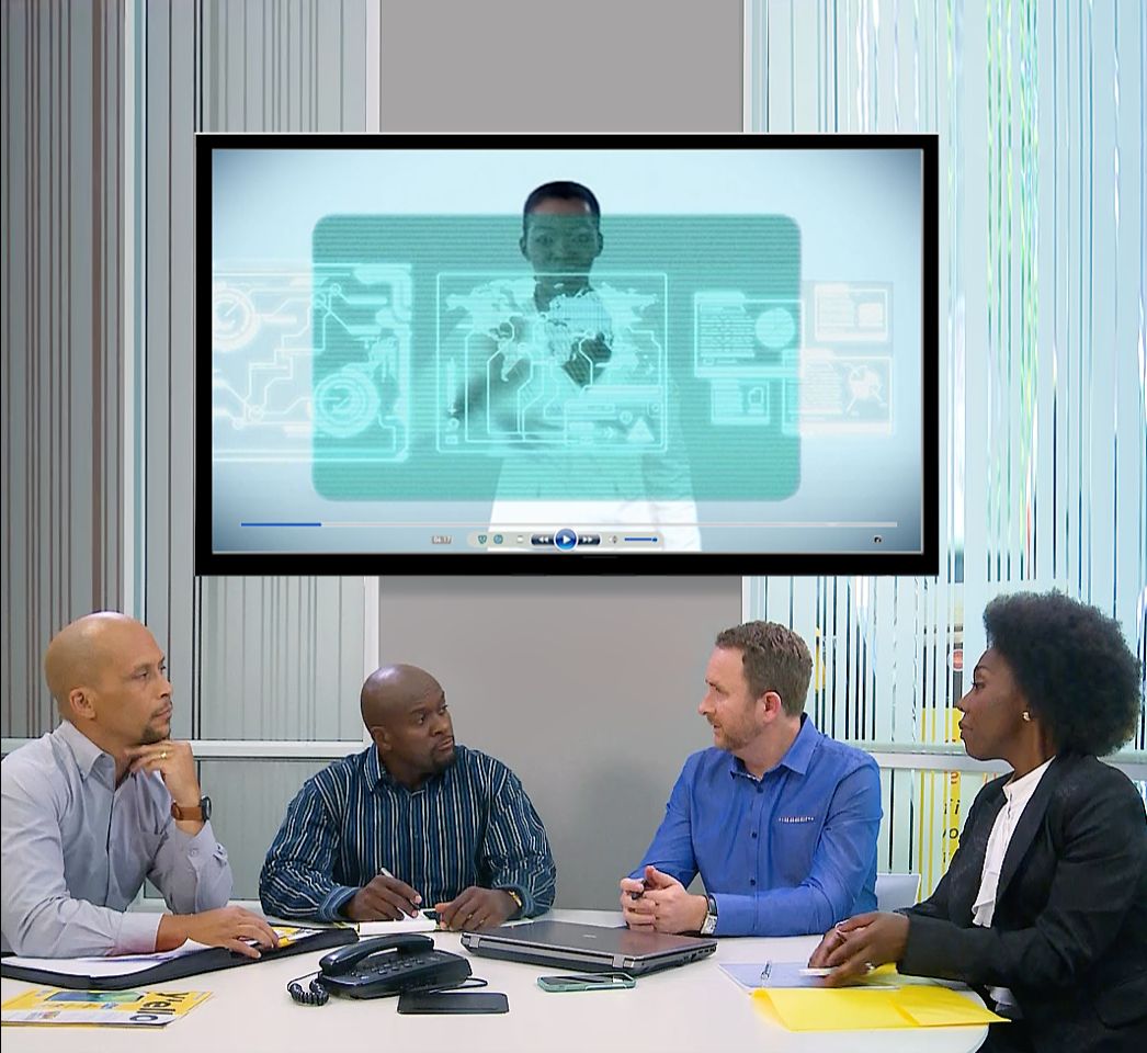 Three colleagues in a meeting around a table